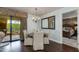 Well-lit dining area with a chandelier, balcony access, and a view into the bedroom space at 7181 E Camelback Rd # 208, Scottsdale, AZ 85251