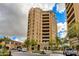 Exterior showcases a luxury high-rise building with manicured landscaping, sidewalks, and street parking at 7181 E Camelback Rd # 208, Scottsdale, AZ 85251