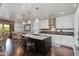 Modern kitchen featuring white cabinets, dark countertops, a large island, and bar stool seating at 7181 E Camelback Rd # 208, Scottsdale, AZ 85251