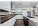 Modern kitchen featuring white cabinets, dark countertops, stainless steel appliances, and tile backsplash at 7181 E Camelback Rd # 208, Scottsdale, AZ 85251