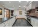 Modern kitchen features stone floors, stainless steel appliances and stylish countertops at 7181 E Camelback Rd # 208, Scottsdale, AZ 85251
