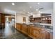 Spacious kitchen featuring custom wood cabinetry, granite countertops, and chef-grade appliances at 7181 E Camelback Rd # 208, Scottsdale, AZ 85251