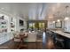 Open-concept living room flows into the kitchen and dining area, featuring a fireplace and balcony access at 7181 E Camelback Rd # 208, Scottsdale, AZ 85251