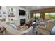Comfortable living room with built-in bookshelves, fireplace, and balcony overlooking the outdoors at 7181 E Camelback Rd # 208, Scottsdale, AZ 85251