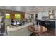 Bright and airy living space seamlessly connects the kitchen and dining area with access to an outdoor balcony at 7181 E Camelback Rd # 208, Scottsdale, AZ 85251