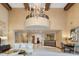 Grandiose lobby with high ceilings, a large chandelier, marble flooring, and stylish furniture at 7181 E Camelback Rd # 208, Scottsdale, AZ 85251
