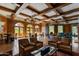 Luxurious lounge featuring wood-paneled walls, exposed beam ceilings, and comfortable seating arrangements at 7181 E Camelback Rd # 208, Scottsdale, AZ 85251