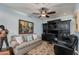 Home office with built-in black shelving, a comfortable sofa, and a ceiling fan for climate control at 7181 E Camelback Rd # 208, Scottsdale, AZ 85251