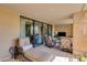 Relaxing outdoor patio with sliding glass doors, comfortable seating, and city views at 7181 E Camelback Rd # 208, Scottsdale, AZ 85251