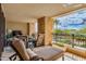 Exterior patio with lounge seating, a TV, and a garden bed with flowering plants at 7181 E Camelback Rd # 208, Scottsdale, AZ 85251