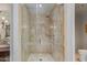Walk-in shower featuring a glass enclosure, neutral tile, and a rainfall showerhead at 7181 E Camelback Rd # 208, Scottsdale, AZ 85251