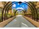 Picturesque arched walkway offers a serene and inviting entrance to the property at 7181 E Camelback Rd # 208, Scottsdale, AZ 85251