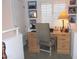 Bright office nook with neutral color scheme, wood desk, ergonomic chair, and natural light through window blinds at 7710 E Gainey Ranch E Rd # 115, Scottsdale, AZ 85258