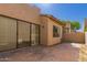Backyard exterior featuring stucco walls, a window, a sliding glass door, and a brick patio at 7955 E Chaparral Rd # 120, Scottsdale, AZ 85250