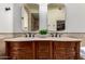 Bathroom with double sinks, marble countertop and decorative tile backsplash at 7955 E Chaparral Rd # 120, Scottsdale, AZ 85250