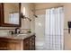 Bathroom features a marble vanity and a shower with a white curtain at 7955 E Chaparral Rd # 120, Scottsdale, AZ 85250