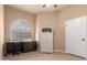 Bedroom features desk, cabinet, arched window, and neutral color palette at 7955 E Chaparral Rd # 120, Scottsdale, AZ 85250