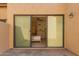 Bedroom featuring a slider door with open view of dresser, ceiling fan and bed at 7955 E Chaparral Rd # 120, Scottsdale, AZ 85250