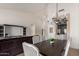 Bright dining area featuring a stylish chandelier, views to the living room and kitchen at 7955 E Chaparral Rd # 120, Scottsdale, AZ 85250
