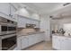 Bright kitchen features white cabinetry, stainless appliances, and tile backsplash at 7955 E Chaparral Rd # 120, Scottsdale, AZ 85250