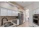 Well-lit kitchen features white cabinetry, stainless appliances, and tile flooring at 7955 E Chaparral Rd # 120, Scottsdale, AZ 85250