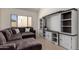Comfortable living room showcasing a large sectional sofa and custom shelving unit at 7955 E Chaparral Rd # 120, Scottsdale, AZ 85250