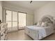 Main bedroom with sliding glass doors to patio and neutral decor at 7955 E Chaparral Rd # 120, Scottsdale, AZ 85250
