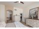 Main bedroom with neutral paint, arched doorway to the bathroom, and tile flooring at 7955 E Chaparral Rd # 120, Scottsdale, AZ 85250