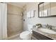 Bathroom features a tiled walk-in shower, dark vanity, and neutral finishes at 8107 E Mitchell Dr, Scottsdale, AZ 85251