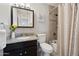 Well-lit bathroom features a shower over tub, dark vanity, and neutral finishes at 8107 E Mitchell Dr, Scottsdale, AZ 85251