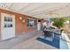 The home features a covered patio with an outdoor ceiling fan, dining table, and a grill for easy entertaining at 8107 E Mitchell Dr, Scottsdale, AZ 85251