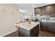 Open concept kitchen features dark cabinetry, granite countertops, an island, and stainless steel appliances at 8107 E Mitchell Dr, Scottsdale, AZ 85251