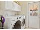 Bright laundry room equipped with washer, dryer, and storage at 8107 E Mitchell Dr, Scottsdale, AZ 85251