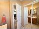 Comfortable half-bathroom featuring tiled floors, vanity with mirror, traditional toilet and hall access at 903 S Mineshaft Dr, Apache Junction, AZ 85119