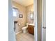 Comfortable half-bathroom with tiled floors, window, traditional toilet and vanity at 903 S Mineshaft Dr, Apache Junction, AZ 85119