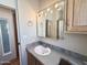 Bathroom with sink, mirror, and wooden cabinets at 903 S Mineshaft Dr, Apache Junction, AZ 85119