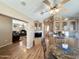 Cozy dining area featuring a ceiling fan, wood floors, built-in cabinets, and seating for four at 903 S Mineshaft Dr, Apache Junction, AZ 85119