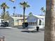 Street view of homes featuring desert landscaping and mature palm trees at 903 S Mineshaft Dr, Apache Junction, AZ 85119