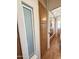 Hallway with laminate floors, neutral walls, built in storage, and window at 903 S Mineshaft Dr, Apache Junction, AZ 85119