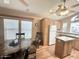 Well-lit kitchen with three ceiling fans, breakfast nook, stainless sink and bright, natural wood design at 903 S Mineshaft Dr, Apache Junction, AZ 85119