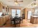 Well-lit kitchen with ceiling fan, breakfast nook, stainless sink and bright, natural wood cabinets at 903 S Mineshaft Dr, Apache Junction, AZ 85119