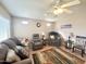 Comfortable living room with neutral walls, ceiling fan, and cozy furniture with natural light at 903 S Mineshaft Dr, Apache Junction, AZ 85119