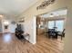 Inviting living room with wood floors open to dining area with modern light fixture and decor at 903 S Mineshaft Dr, Apache Junction, AZ 85119