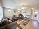 Comfortable living room with neutral walls, ceiling fan, and cozy furniture with natural light at 903 S Mineshaft Dr, Apache Junction, AZ 85119