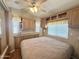 Comfortable main bedroom with a ceiling fan and plenty of built in cabinet and storage space at 903 S Mineshaft Dr, Apache Junction, AZ 85119