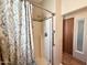 Clean shower with glass door, silver hardware, and decorative curtain at 903 S Mineshaft Dr, Apache Junction, AZ 85119
