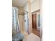 Clean shower with glass door, silver hardware, decorative curtain, and built in seat at 903 S Mineshaft Dr, Apache Junction, AZ 85119