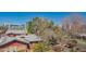 A partial aerial view of the red brick apartment and the surrounding urban neighborhood and mature trees at 920 S Ash Ave, Tempe, AZ 85281