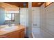 Bright bathroom with modern tile, wood vanity, and combined shower and tub at 920 S Ash Ave, Tempe, AZ 85281