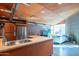 Modern kitchen featuring a butcher block island and stainless steel appliances that open to living area at 920 S Ash Ave, Tempe, AZ 85281